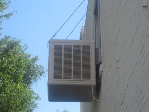Evaporative air cooler mounted on a window